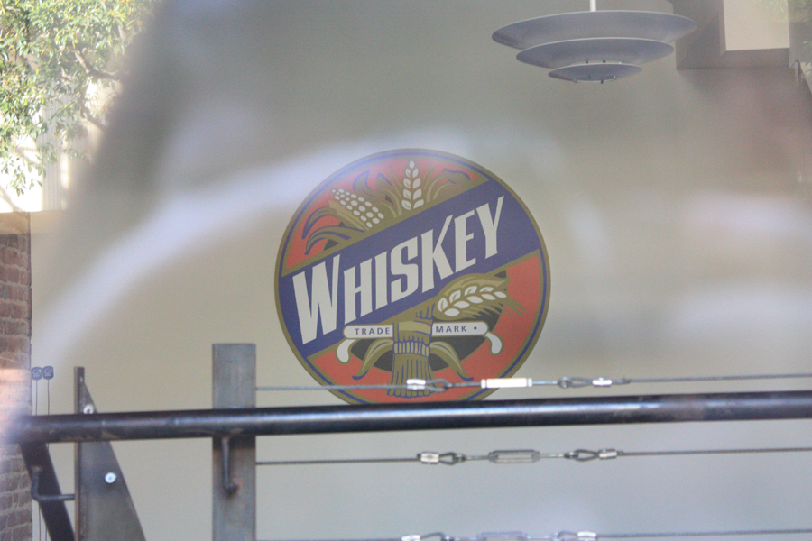  A big whiskey logo atop the stairway into the office