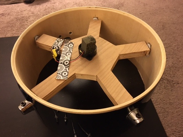 My piezo sensor, mounted to the wooden platform with a section of foam blocks attached to the sensor. The sensor pictured is housed in a plastic shell, but if yours show up with only the naked piezo sensor disk, that should be just fine.