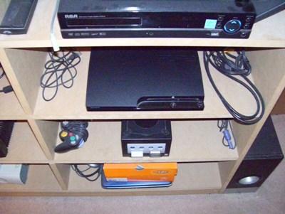  PS3 and Gamecube. Unfortunately, my N64, SNES and NES are in storage. Also, old, shitty laptop is shitty. (Under Lugz box)