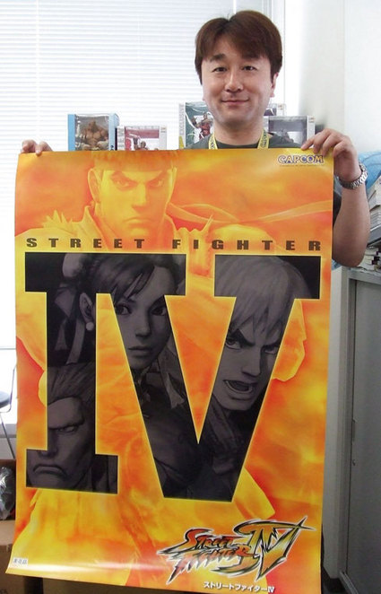 Ono Holding a Pre-Release Poster Advertising Street Fighter 4 
