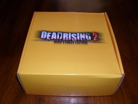   Today I received my copy of Dead Rising 2: High Stakes Edition. It cost $90 (after 2 day shipping that levies out to about $110). And like  any limited editon. It is full of weird stuff. Is it necessarily worth  the extra money? To each their own, I rationalize it as buying a Dead  Rising poker set for $40. Not a bad deal at all. Rationalization aside.  Lets see what we have here. A rational place to start is the box. Nothing too fancy with the box. It's a yellow box.