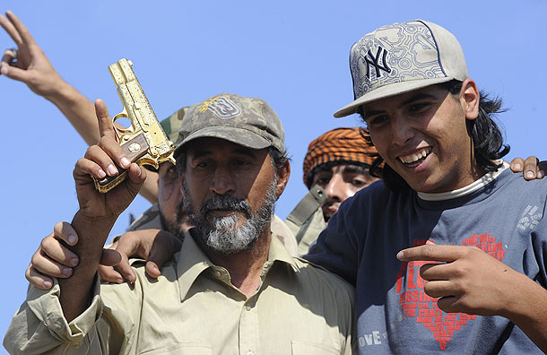 Gaddafi's golden pistol was brandished by the crowd