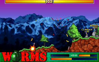 A Banana Bomb causing widespread destruction. At top, opposing players' health bars can be seen; within the lower HUD, a wind strength indicator (top right) and power bar (bottom right) are visible.
