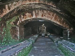 Example of a Mithraeum, with statue of Mithras and the tauroctony visible in the background. 