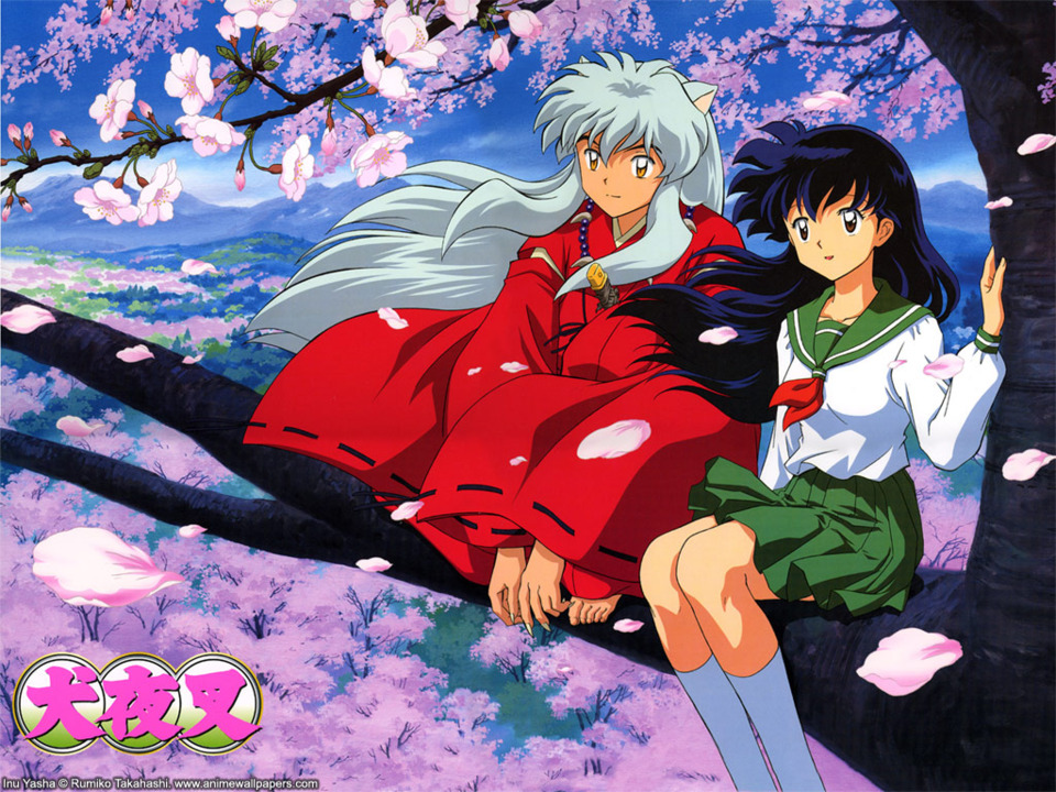 Kagome sits with Inuyasha amidst the cherry blossoms