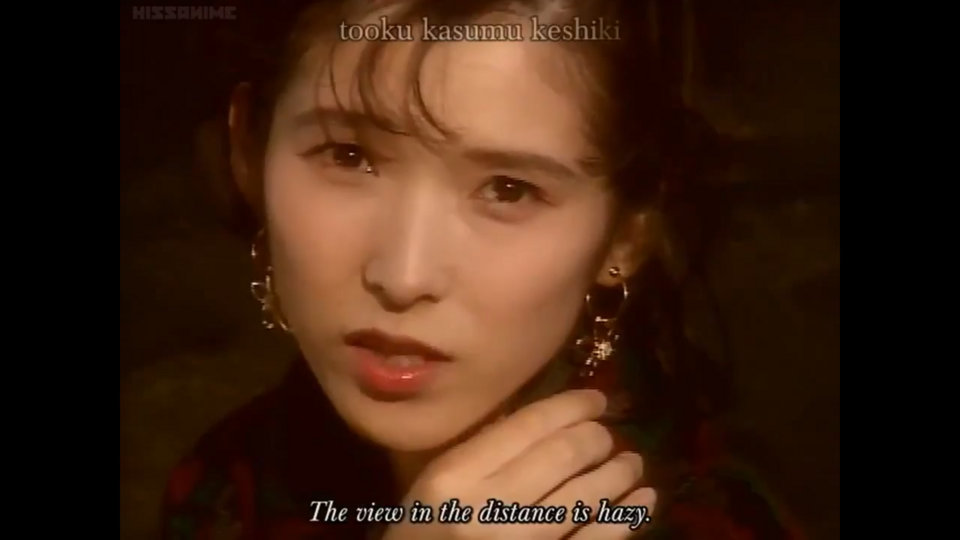 The singer here for the first live-action segment is actually Aya Hisakawa, the seiyuu for Yohko (the ADV Films dub instead has Amanda Winn-Lee, the future Rei Ayanami and Yukiko Amagi). Devil Hunter Yohko was relatively early in Aya's career and she's done a metric ton of voices since, both in anime and video games. The second live-action segment is performed instead by Konami Yoshida, Azusa's seiyuu. And talking of Konami...
