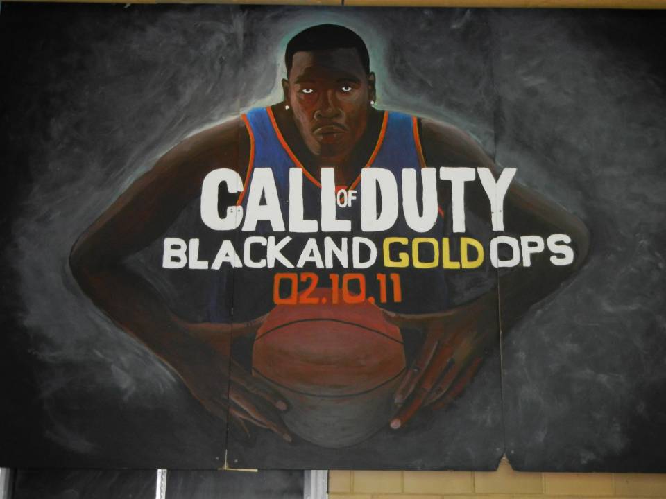  A friend of mine worked on this one and it is fantastic!  It is three panels making it one of the biggest in the gym, and the clever play on the BLOPS cover is awesome.  My school's colours are black and gold just so you know, and the 2/10/11 refers to the day the tournament started.       