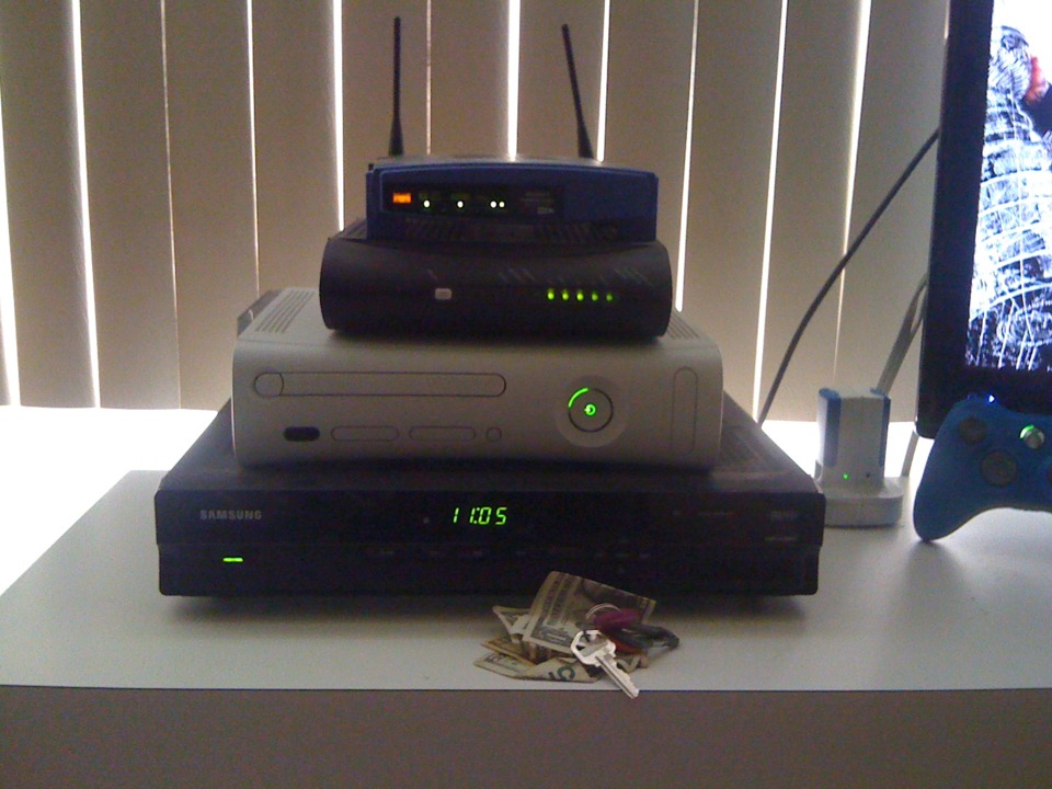 From top to bottom: Linksys router, modem, Xbox 360 arcade, Cable box.  