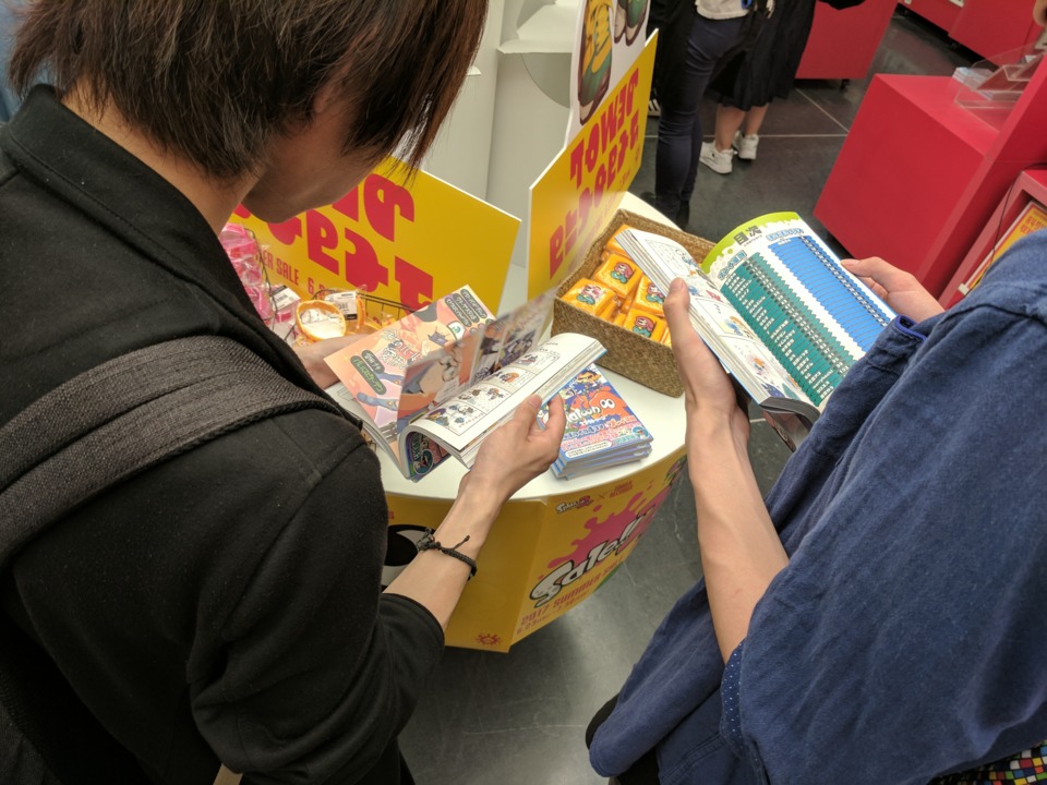 People reading the manga compilation book