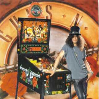 Slash leaning on a Guns n' Roses pinball machine.  Dig the hat!